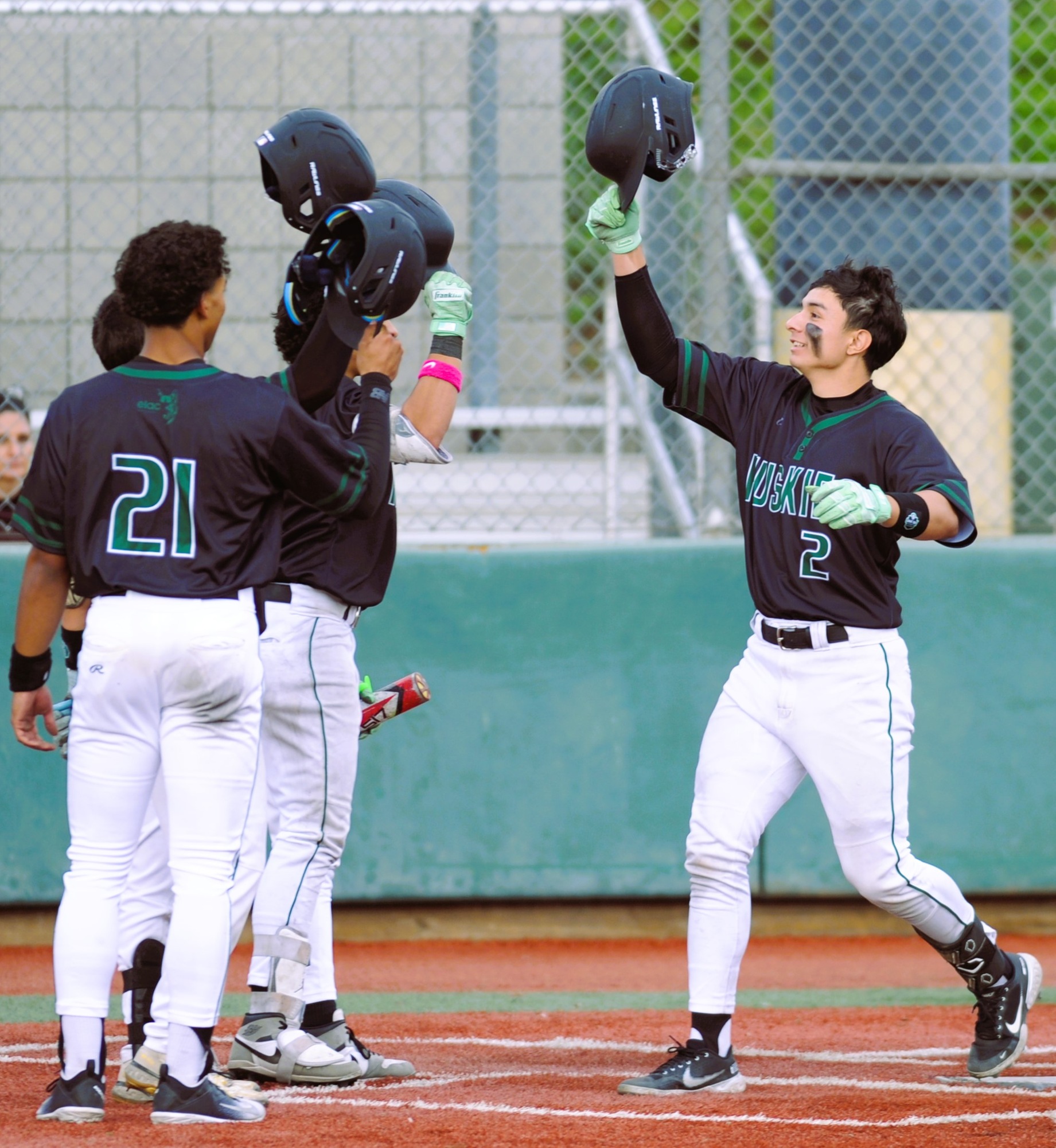 Evan Chavez celebrates with his teammates after his home run