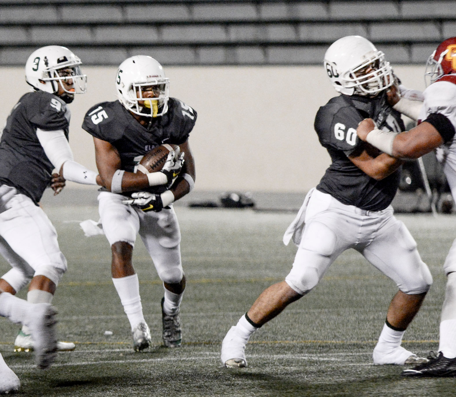 Three sophomores complete a perfect designed play. Quarterback Jonathan Santos (#9) fakes a right pass, then hands left to running back Shaquille Shelton, who runs through a hole created by offensive lineman John Flores (#60) in a 30-24 win vs. Glendale on Nov. 12.