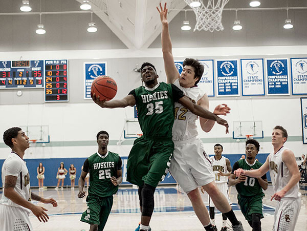 MID-AIR PUSH -- East Los Angeles College freshman forward Marquis Salmon (#35) attempts a layup guarded by Saddleback sophomore center Conor Clifford with 13:50 left in the game in a 50-47 Husky loss to the Gauchos in the CCCAA men's basketball title game on March 15 in Norwalk.                 photo by Tadzio Garcia