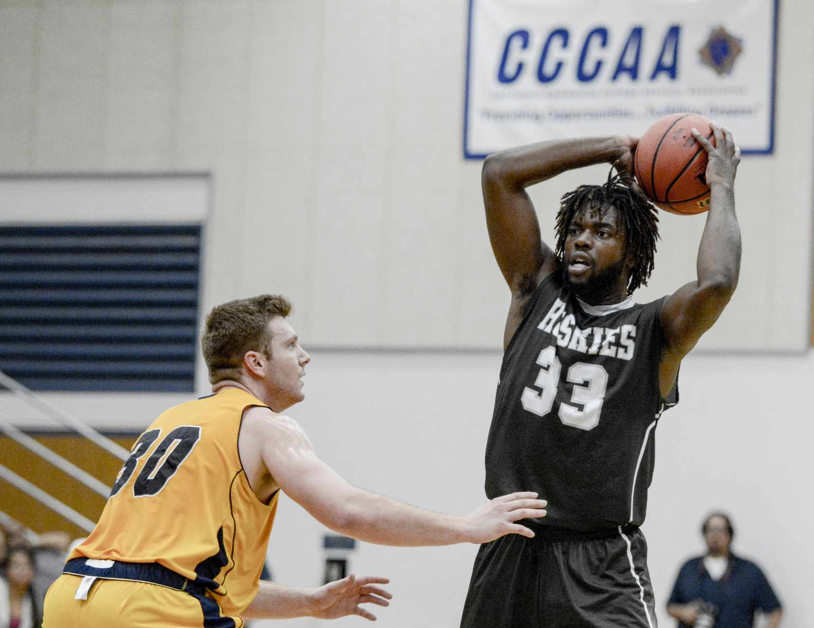 East los Angeles College sophomore forward Chima Wami attempts to pass the ball around a College of the Canyons defender in an 87-84 Huskies win for the Clash at Canyons tournament title. (Photo by Tadzio Garcia)