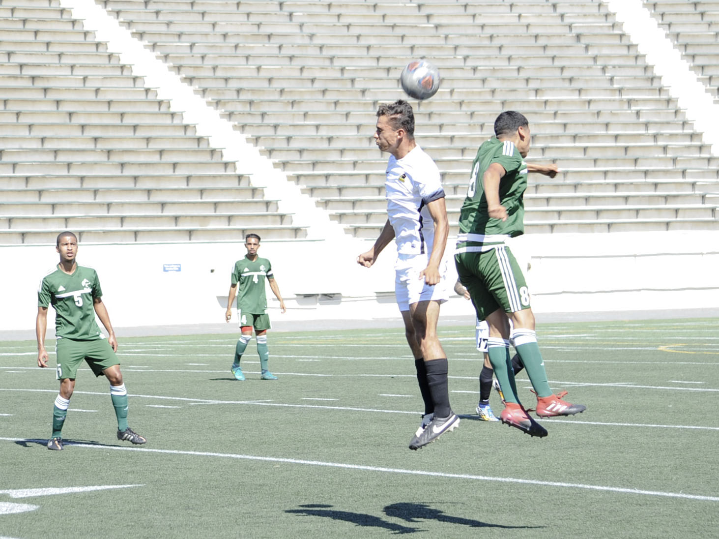 Huskies sophomore Edwin Vasquez is mid air with a header pass to sophomore Gustavo Silva (No. 5) in a 1-0 win vs. Rio Hondo College. (Photo by Tadzio Garcia)