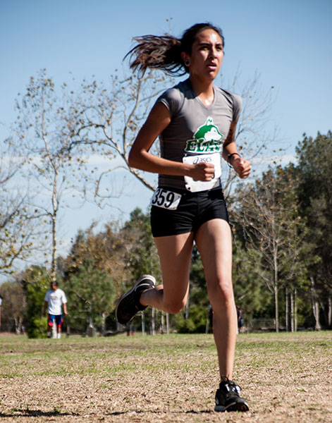 LOOK OF DETERMINATION&mdash;Freshman Rosa Arellano sprints at the finish line to score for the East Los Angeles College women&rsquo;s cross country at the 2015 Golden West Classic, Friday Sept. 25, to help the team place eighth. ( Photo by  Tadzio Garcia )